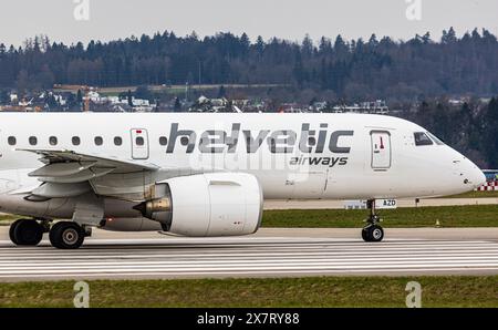 An Embraer 190-E2 from Helvetic Airways waits onto the runway at Zurich Airport for clearance to take off. Registration HB-AZD. (Zurich, Switzerland, Stock Photo