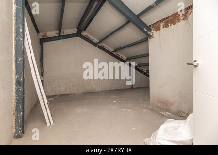 A room with a raw finish on the attic floor of a building. Stock Photo