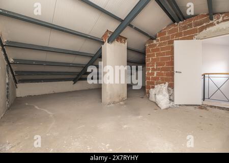 A raw finished room with access via a staircase in the attic of a building Stock Photo