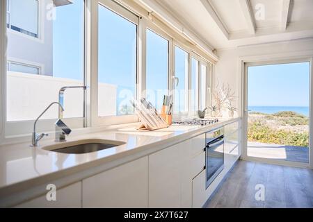 Interior Shot Showing Kitchen In Beautiful Sea Front Property With Views Of Ocean Stock Photo