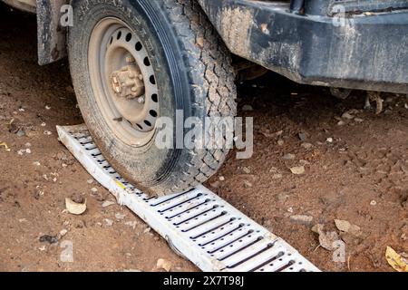 Recovery equipment for unstacking 4x4 vehicle out of muddy road, sand plates, mechanical winch, pooling ropes, high lift jack, shovel Stock Photo