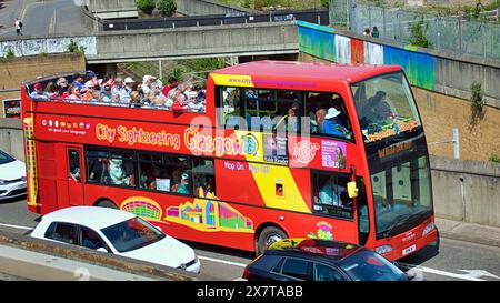 Glasgow, Scotland, UK. 21st May, 2024: UK Weather:  Glasgow tours tourist bus on the clydeside expressway on the way from the riverside museum. Hot weather saw an arrival of summer as  locals and tourists in the city took to the city centre at lunchtime. Credit Gerard Ferry/Alamy Live News Stock Photo