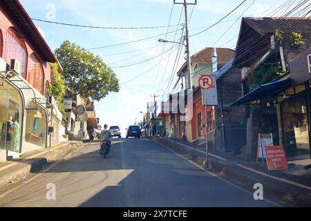 Ubud, Bali in Indonesia - January 31 2024: Cars and motobikes drive on the streets of Bali Stock Photo