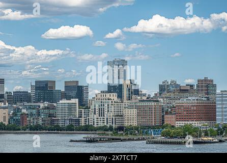 New York, NY, USA - August 1, 2023: Pier 25 and 26 and facades north of Hubert street. Green waterfront park along Hudson river, under blue cloudscape Stock Photo