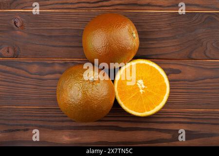 sliced chocolate oranges on wood background Stock Photo