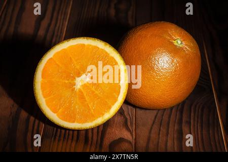 sliced chocolate oranges on wood background Stock Photo