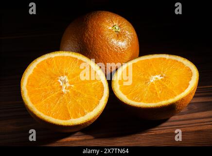 sliced chocolate oranges on wood background Stock Photo