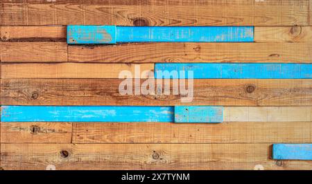 A wooden panel made with rustic wooden slats, unpainted wood, and some blue-colored slats. Stock Photo