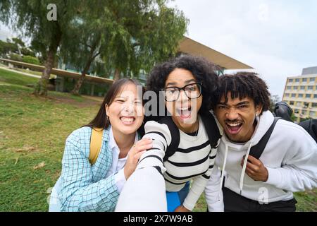 three young multiethnic students taking selfie Stock Photo