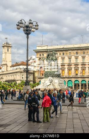Police officers chat with street performer Salvo The Best, famous for dancing every day in the city centre of Milan, Lombardy, Italy Stock Photo