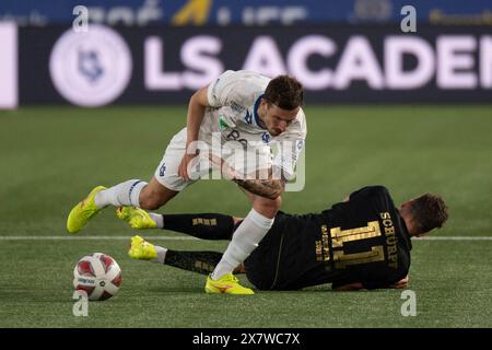 Lausanne, Switzerland. 21 May, 2024:  Olivie Custodio (middle) of FC Lausanne-Sport #10 tackles Pascal Schürpf (midfielder) of Grasshopper Club Zürich #11 during  FC Lausanne Sport vs Grasshopper Club Zürich at  Tuiliere Stadium in Lausanne. Credit: Patrick Dancel/Alamy Live News Stock Photo