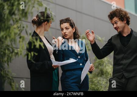 Business professionals having a discussion outside office building Stock Photo