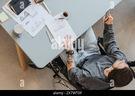 Business Professional Reviewing Charts in Modern Office. Stock Photo