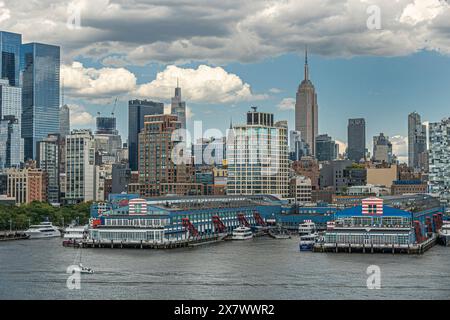 New York, NY, USA - August 1, 2023: White and blue sports and events buildings on Chelsea piers between 19th and 21st streets west with red stairways. Stock Photo