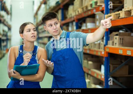 Confident two workers taking inventory of goods in building materials store Stock Photo