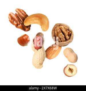 Many different nuts in air on white background Stock Photo