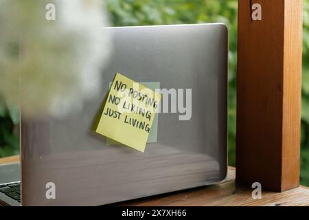 Paper note with TAKE A BREAK FROM TECHNOLOGY messages hangs from rope ...