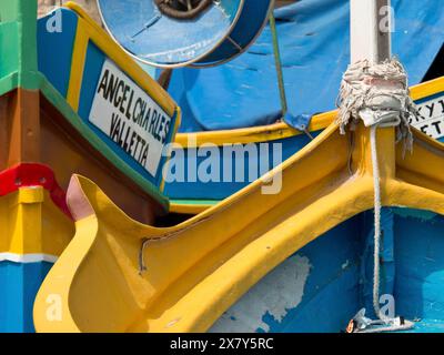 Colourful fishing boats in the harbour with different coloured details and a sign, many colourful fishing boats in a harbour in the Mediterranean Sea, Stock Photo