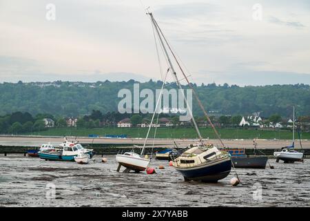 Small boats moored in the harbour at Rhos-on-Sea, Wales, Uk at low tide. Stock Photo
