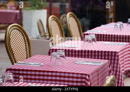 Tables on a restaurant terrace with a typical red checkered tablecloth Stock Photo