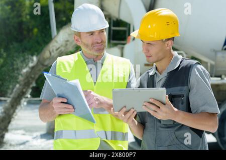 two construction workers are outdoors Stock Photo