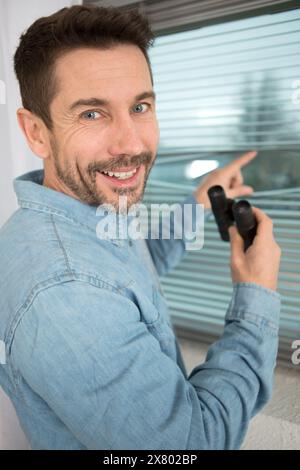 happy suspicious skeptic and confused man with binoculars Stock Photo