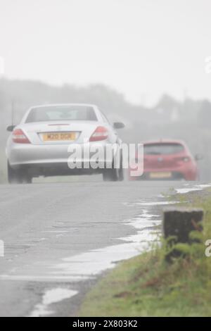 Flintshire, North Wales UK. UK Weather. 22nd May 2024, severe weather warning in place over North Wales with a Met Office Amber Warning for rain issued, Flintshire and North Wales.  Motorists travelling throuigh the amber warning for rain in the area, Halkyn Mountian, Flintshire ©DGDImages/Alamy Live News Stock Photo