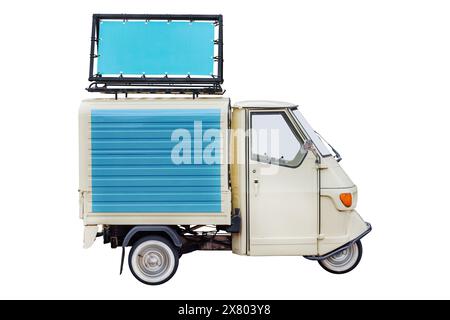 Vintage Italian three wheeled scooter van with advertising banner on the roof isolated on a white background Stock Photo