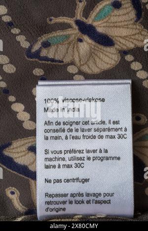 washing care instructions label in The Masai Clothing Company woman's top clothing garment 100% viscose made in India Stock Photo