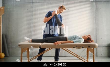 Sport Physiotherapy Specialist Stretching and Working on Specific Muscle Groups or Joints with Elderly Woman. MIddle Aged Female Recovering from Mild Injury, Undergoing Rehabilitation. Stock Photo