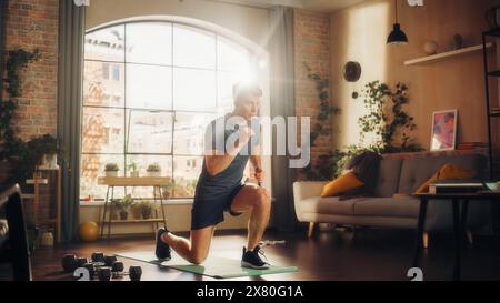 Strong Athletic Fit Young Man Doing Cardio and Squats Core Strengthening Exercises During Morning Workout at Home in Sunny Apartment. Fitness and Recreation Concept. Stock Photo