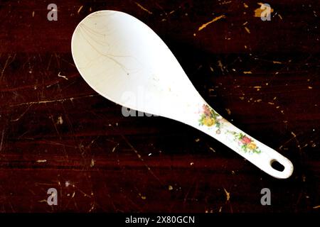 Plastic spoon on wood background Stock Photo