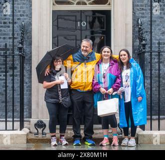 London, England, UK. 22nd May, 2024. FIGEN MURRAY, mother of Manchester Arena bombing victim Martyn Hett, arrives in Downing Street, London with (left to right) husband Stuart Murray, and daughters Nikita Murray and Louise Webster, to hand in a letter about Martyn's Law to Number 10, after her 200-mile walk to London from the spot where her son was killed in Manchester. Credit: ZUMA Press, Inc./Alamy Live News Stock Photo