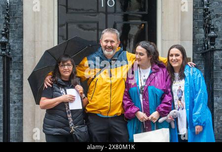 London, England, UK. 22nd May, 2024. FIGEN MURRAY, mother of Manchester Arena bombing victim Martyn Hett, arrives in Downing Street, London with (left to right) husband Stuart Murray, and daughters Nikita Murray and Louise Webster, to hand in a letter about Martyn's Law to Number 10, after her 200-mile walk to London from the spot where her son was killed in Manchester. Credit: ZUMA Press, Inc./Alamy Live News Stock Photo