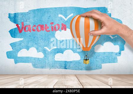 Colorful hot air balloon with vacation text cloud Stock Photo