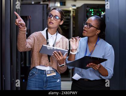 Server, technician and people programming maintenance on tablet with teamwork in IT and engineering. Datacenter, repair and programmer with engineer Stock Photo