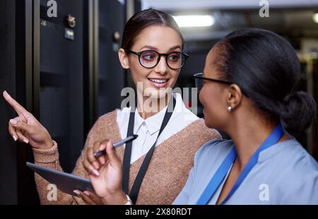 Programming, server and people with maintenance of technology and IT technician with teamwork. Datacenter, repair and problem solving to fix glitch Stock Photo
