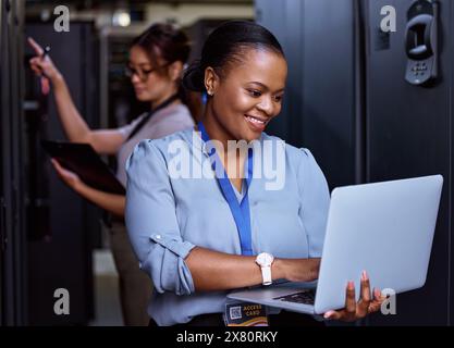 Server, technician and people programming maintenance on laptop with teamwork in IT and engineering. Datacenter, repair and programmer with engineer Stock Photo