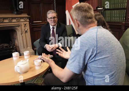 Figen Murray, mother of Manchester Arena bombing victim Martyn Hett, and her husband Stuart speaking to Labour Party leader Sir Keir Starmer (left) about Martyn's Law in the Houses of Parliament in London, after her 200-mile walk to London from the spot where her son was killed in Manchester. Martyn's Law is named in tribute to the 29-year-old who was one of 22 people killed at the end of an Ariana Grande concert in May 2017, and would require venues and local authorities in the UK to have preventative plans against terror attacks. Picture date: Wednesday May 22, 2024. Stock Photo
