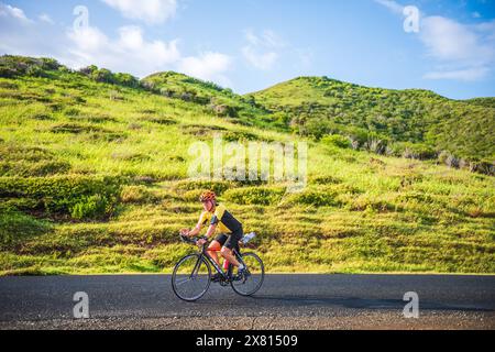 St. Croix, US Virgin Islands - September 9, 2016: Caucasian man rides a bike on the tropical island of St. Croix. Stock Photo