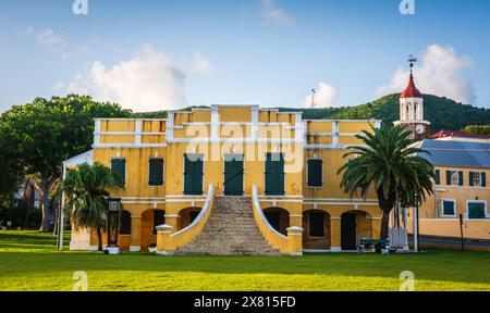 St. Croix, US Virgin Islands - September 10, 2016:Bright yellow historic building is central to Christiansted National Historic Site. Stock Photo