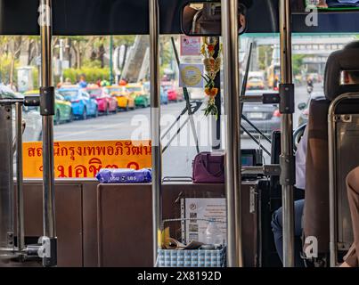 BANGKOK, THAILAND, MAY 19 2024, View through the window of a moving bus in the city center at the late afternoon Stock Photo