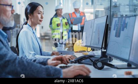 Factory Office Room: Industrial Engineers Developing Models of a Heavy Industry Machine Parts on a Computer 3D Software. Modern Technological Research and Development Center. Stock Photo
