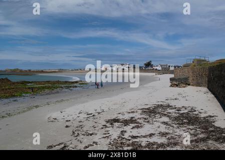 Looking along the impressive popular white sandy beach of Cobo Bay Castel Guernsey Channel Islands on a lovely sunny May day Stock Photo