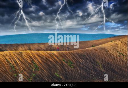 lightning over a hilly field. landscape with dramatic thunderclouds in the background. nature of Ukraine Stock Photo