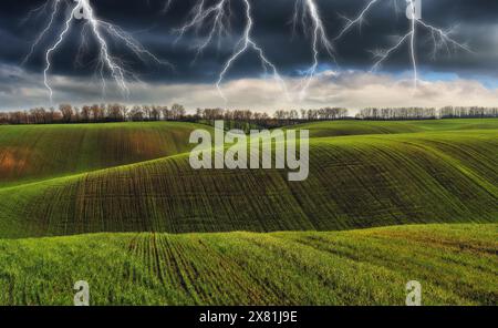 lightning over a hilly field. landscape with dramatic thunderclouds in the background. nature of Ukraine Stock Photo