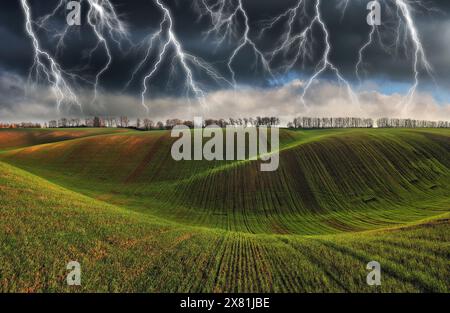 lightning over a hilly field. landscape with dramatic thunderclouds in the background. nature of Ukraine Stock Photo