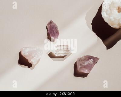 Collection of crystals quartz and amethyst on a beige background with shadows from sunlight. Top view. Copy space Stock Photo