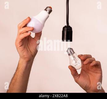 replacing an old lamp with an energy-saving one Stock Photo