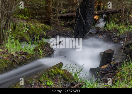 Small creek on slope between Brig town and Simplonpass in spring sunny morning Stock Photo